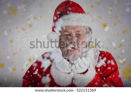 Playful Santa Claus blowing fake snow against snowflake pattern