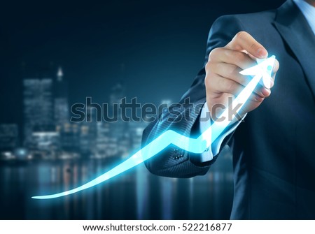 Close view of businessman drawing on screen growing graph Royalty-Free Stock Photo #522216877