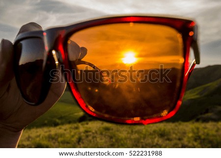 sunset through travelers glasses