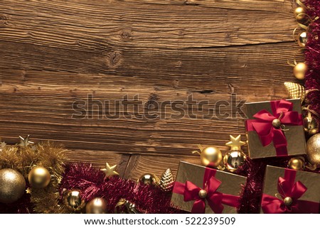 Golden presents with red ribbon. Wooden background and table. Red and gold. Place for typography and logo. Copyspace. Top view.