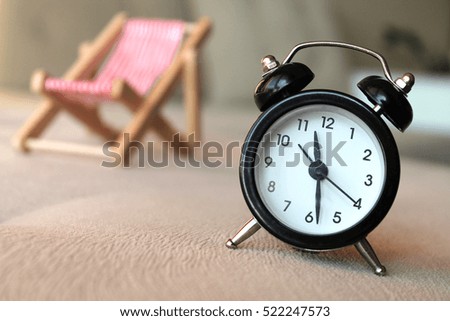 Clock and sunbed. Time to rest concept.