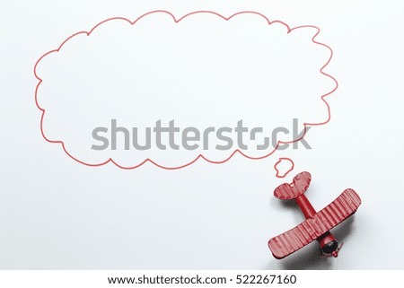 red toy airplane with talk bubble on white background. space for your message. 