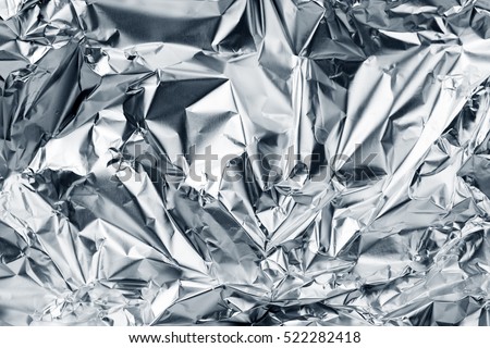 Silver foil background with shiny crumpled surface for texture background Royalty-Free Stock Photo #522282418