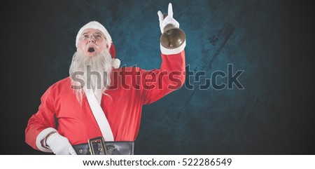 Santa claus ringing bell against dark background