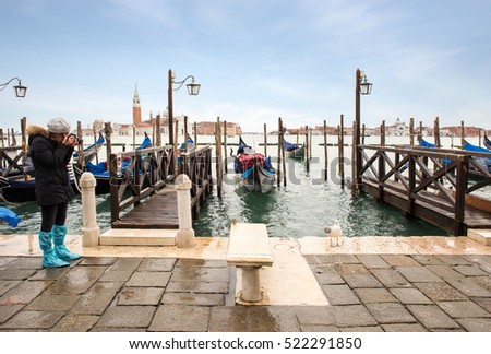 girl taking picture of a typical venetian situation