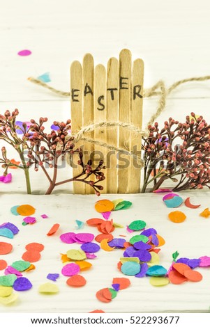 the word Easter in the conceptual block text on wooden sticks, a fun colored background