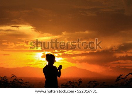 Silhouette of girl and beautiful sunset at the view point of Songkhla zoo.