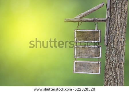 Wood Sign Board hanging with Rope on a grass background