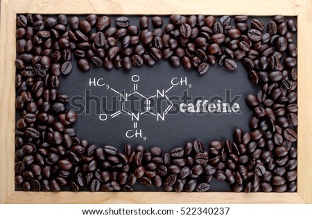 Caffeine chemical formula on chalkboard with coffee beans Royalty-Free Stock Photo #522340237