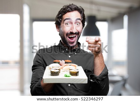 young man eating sushi. show sign