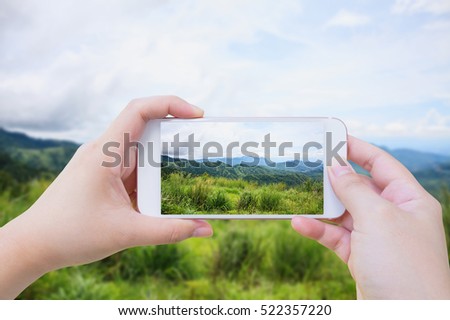 Female using mobile smart phone Taking photo of Beautiful landscape in the mountains