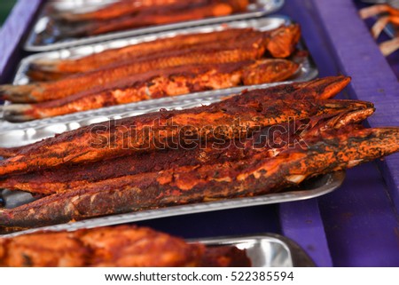 Fresh cooked/roasted/grilled/baked/deep fried hot and spicy mackerel fish fry/seafood in street food shop/stall along shore in Velankanni/Chennai, Tamil Nadu, India. Marinated fish in Indian spices. 