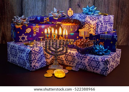 Jewish holiday Hanukkah Beautiful Chanukah decorations in blue and silver with gifts and dreidels and a Chanukiah with nine Chanukah candles for the
