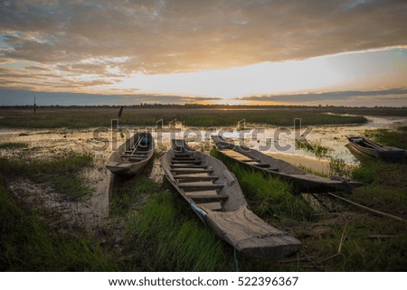 Old wood Fishing boat and lighting after sunset.