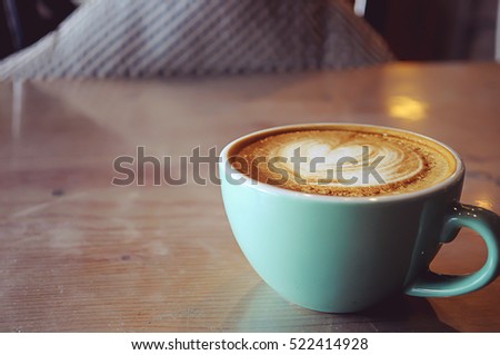 Coffee in blue cup on wooden table