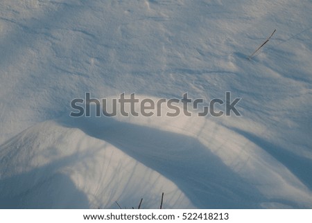 Beautiful winter landscape with snow-covered hills at sunset.