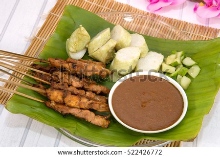Southeast Asia Food, Indonesian Satay with Peanut Sauce, Chicken Satay Served on Banana Leaf in Wooden Tray