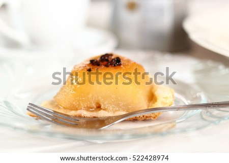 Piece of Pear Tarte Tatin with Cardamom at background Moka Pot and Coffee Cup