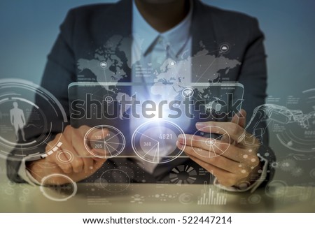woman looks transparent monitor panel that indicates technological graphics, futuristic GUI(Graphical User Interface), IoT(Internet of Things), technological abstract Royalty-Free Stock Photo #522447214