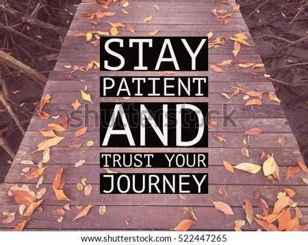 Inspirational motivational quote "stay patient and trust your journey" on wooden walkway with autumn leaves background. Royalty-Free Stock Photo #522447265