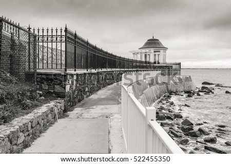The cliffwalk in Newport offers backyard views of famous mansions to one side and a beautiful rocky coastline to the other - Newport, RI, USA Royalty-Free Stock Photo #522455350