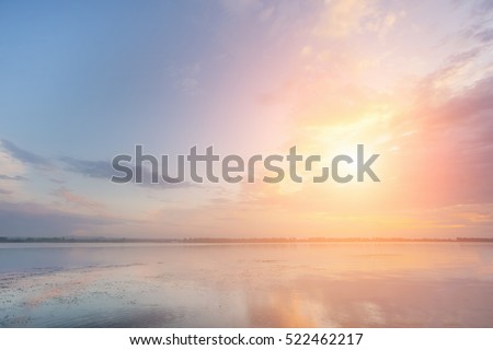 Beautiful sky over the river at sunset or sunrise Royalty-Free Stock Photo #522462217