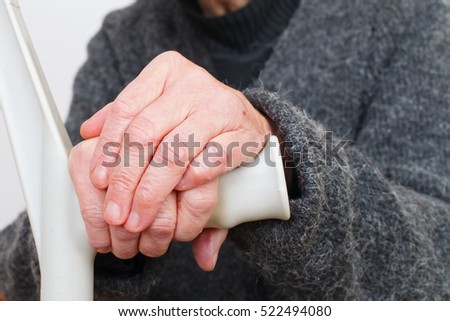 Close up picture of a handicap elderly woman's hand