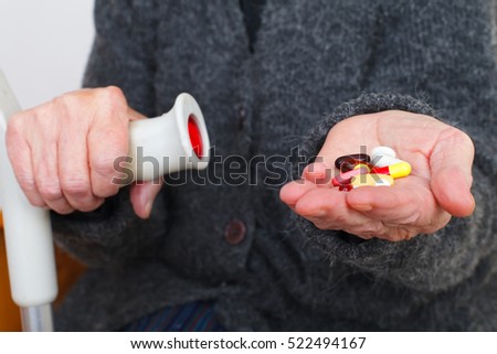 Picture of a senior woman's hand holding pills