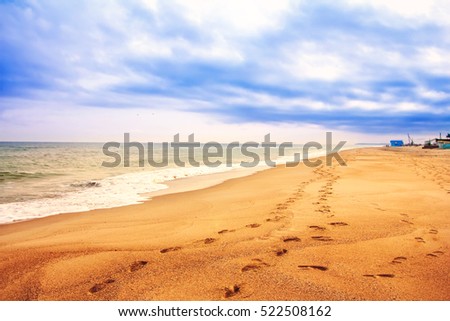 beach footprints in the sand Royalty-Free Stock Photo #522508162