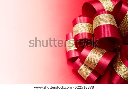A red bow with a red and white background. You can insert text.