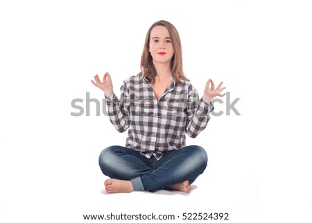
Young girl sitting on the floor in a yoga posture or a religious posture isolated on white background