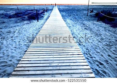Aged wooden pathway on the beach in summer. Bleached and weathered wood floor, for nature business concept, vintage blogs, magazines, books, image with vintage filter effect for retro style