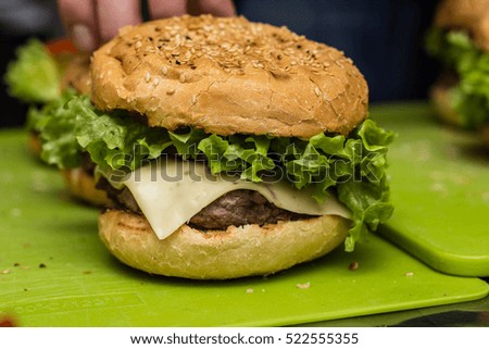 Closeup of home made burgers on green background 
