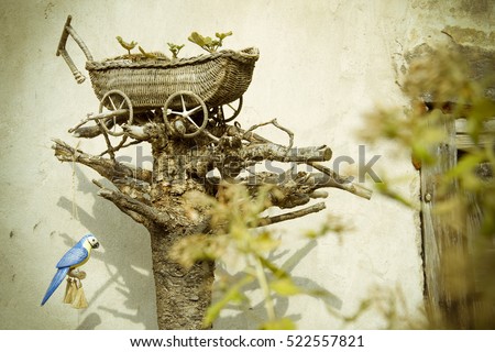 Wooden hand made decoration in the garden. Uzupis. Vilnius. Lithuania Royalty-Free Stock Photo #522557821