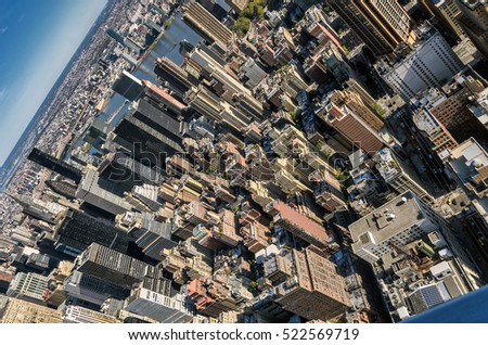 Aerial view of New York city midtown skyscrapers in a clear, sunny day; tilt shot.