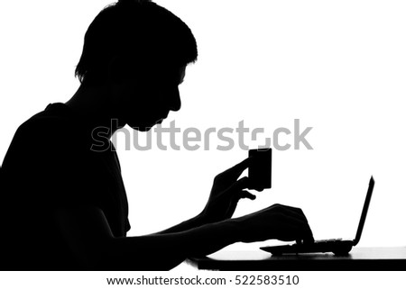 black and white portrait of a young woman shopping online with a credit card