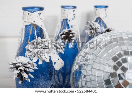 blue glass bottles are decorated for new year  on white wood backgraund. Blue color.