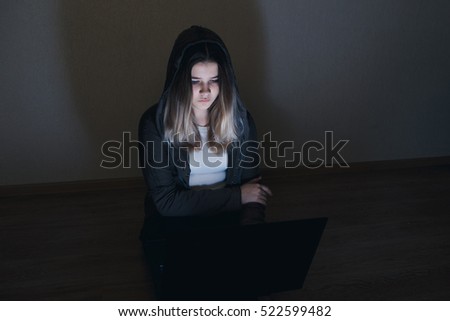 sad and scared female teenager with tablet computer and laptop suffering cyberbullying and harassment being online abused by stalker or gossip feeling desperate and humiliated in cyber bullying