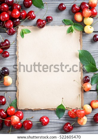 Healthy eating concept. Open recipe book with Cherries on wooden table. Copy space for your text. Top view, high resolution product.
