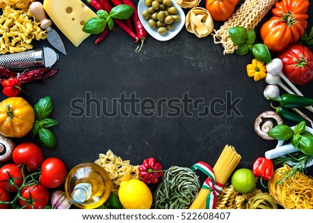 Italian food ingredients. Vegetables, olive oil, cheese, herbs and pasta on dark background