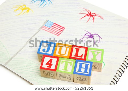 Kid's 4th of July drawing with color pencils and alphabet blocks.