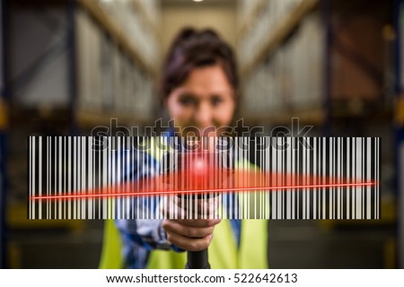 Concept photo of a woman scanning a bar code with a hand scanner in a warehouse. Traceability, FIFO, LIFO, just in time concept photo. Royalty-Free Stock Photo #522642613