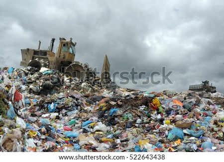 Garbage truck unloading at the dump Royalty-Free Stock Photo #522643438