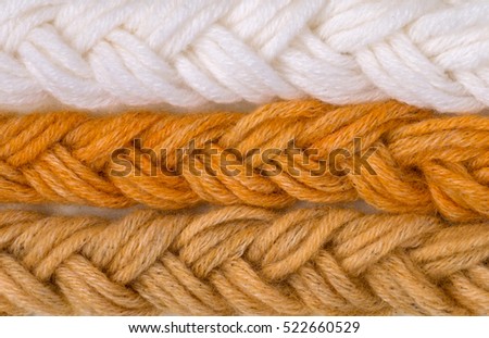 Braided wool yarn swatches colored by henna and henna and amalaki mix and control white sample
