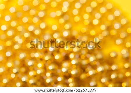 A lights yellow bokeh defocused. Abstract Christmas background with bokeh.