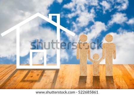 Family figure with a house on wooden background