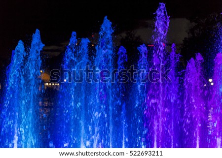 Colorful fountain water spray at night