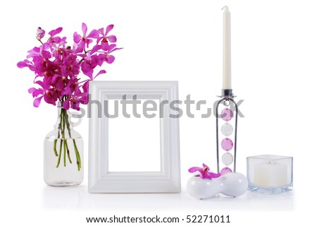 white picture frame in decoration with orchid and candle