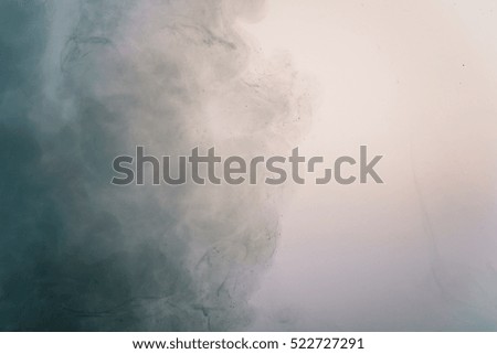 abstract dark blue acrylic paint cloud in water, shallow focus