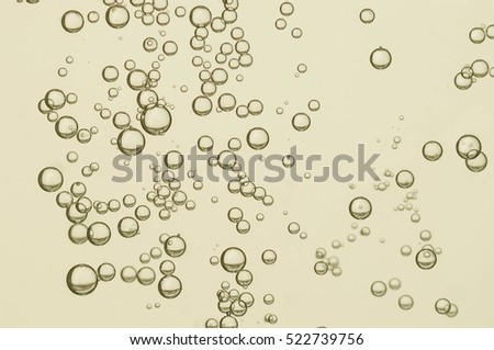 Beautiful golden liquid bubbles over a light background